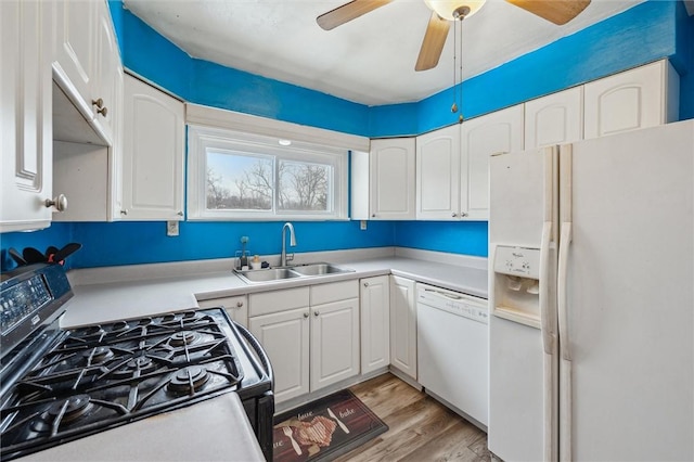 kitchen with white appliances, ceiling fan, sink, light hardwood / wood-style flooring, and white cabinetry