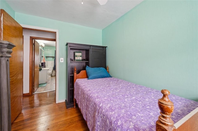 bedroom featuring wood-type flooring and ensuite bath