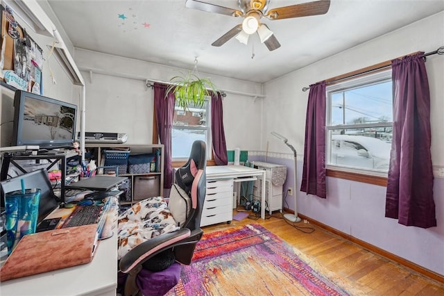 office space with ceiling fan and light hardwood / wood-style floors