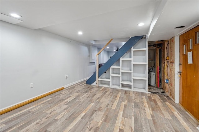 basement with hardwood / wood-style floors