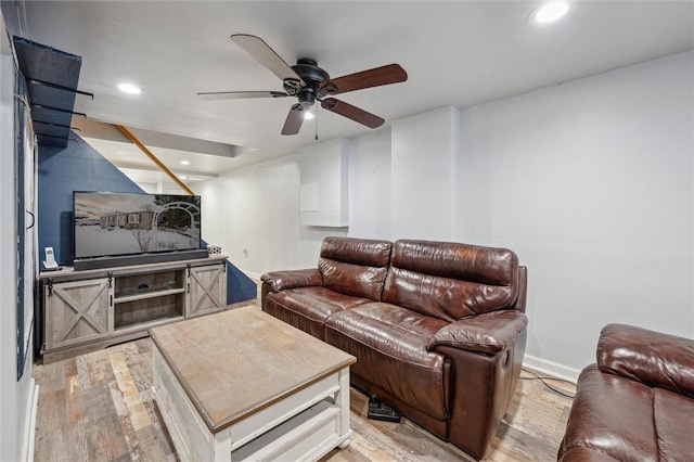 living room featuring light wood-type flooring and ceiling fan