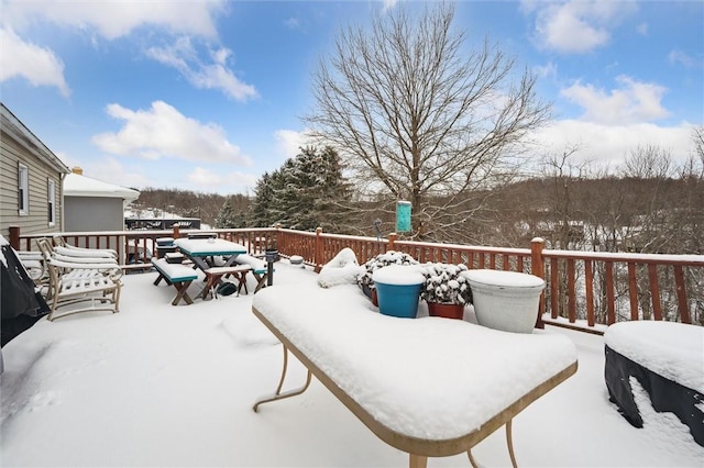 snow covered patio featuring a deck