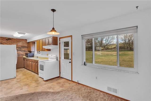 kitchen featuring light carpet, sink, pendant lighting, and white appliances