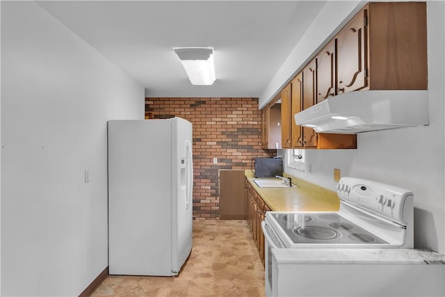 kitchen featuring sink, white appliances, brick wall, and exhaust hood