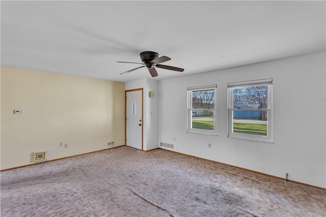 carpeted spare room with ceiling fan