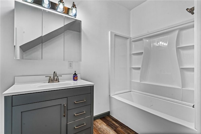 bathroom featuring wood-type flooring, vanity, and tub / shower combination