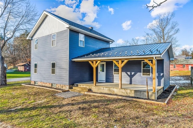 back of property with covered porch