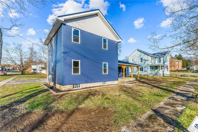 view of property exterior featuring covered porch and a lawn