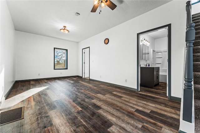 spare room with dark hardwood / wood-style flooring and ceiling fan