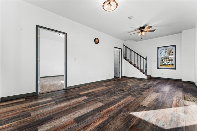 empty room with ceiling fan and dark hardwood / wood-style floors