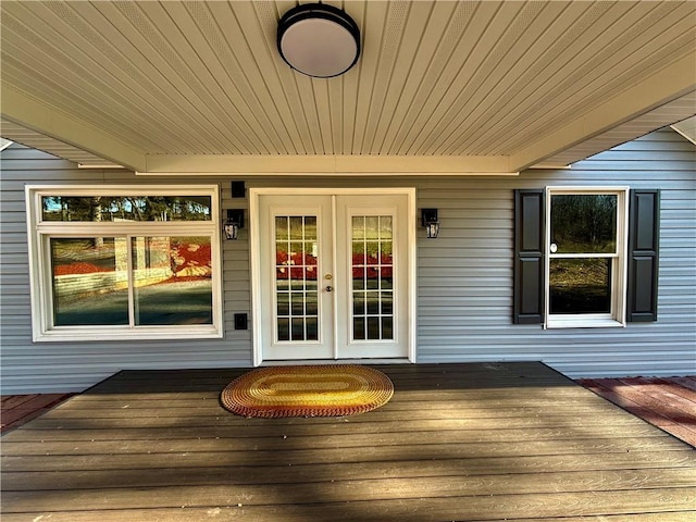 deck featuring covered porch and french doors