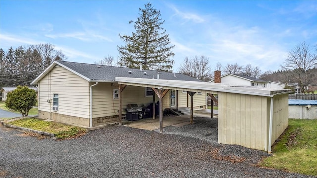 rear view of house featuring a carport