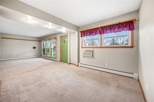 carpeted empty room with plenty of natural light, an AC wall unit, and baseboard heating