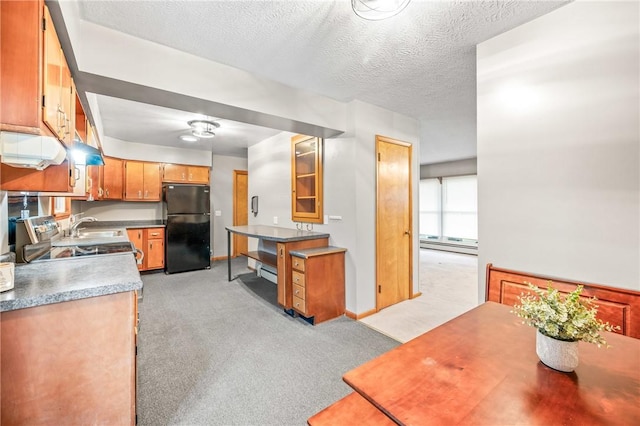 kitchen with black fridge, sink, light carpet, and a textured ceiling