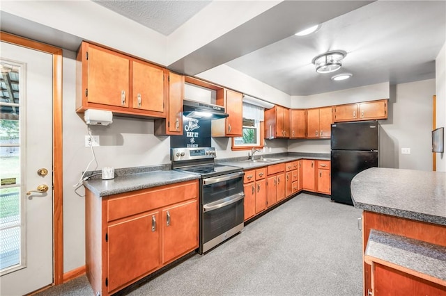 kitchen featuring black refrigerator, electric stove, sink, range hood, and light colored carpet