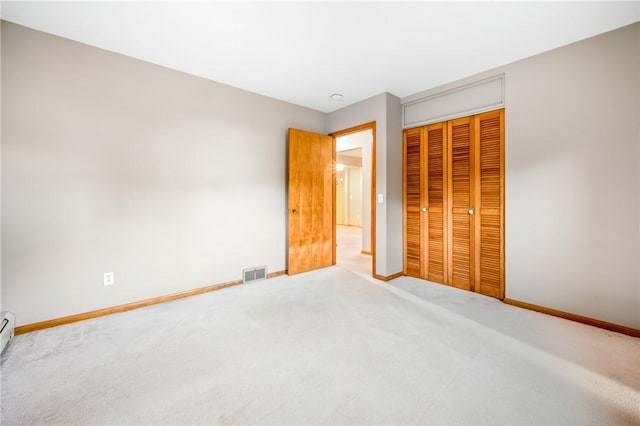 unfurnished bedroom featuring carpet and a closet