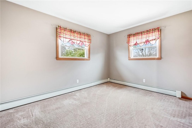 carpeted spare room with a healthy amount of sunlight and a baseboard radiator