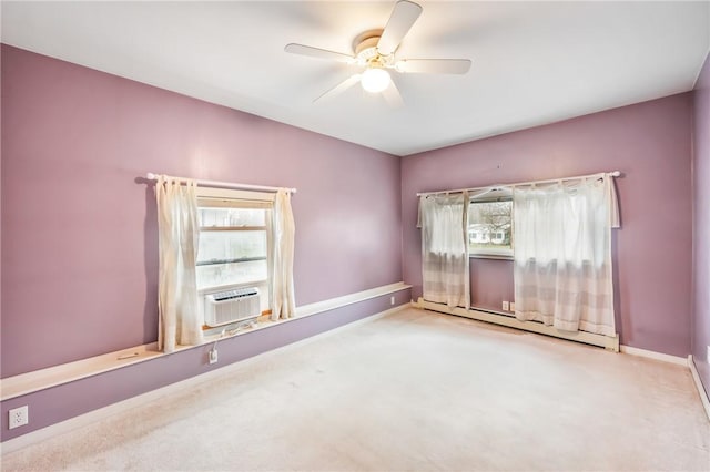 empty room with ceiling fan, cooling unit, light colored carpet, and a baseboard radiator