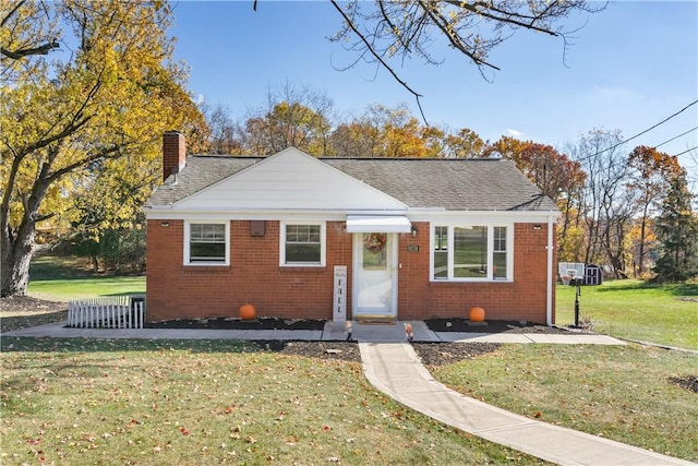 bungalow-style house with a front lawn