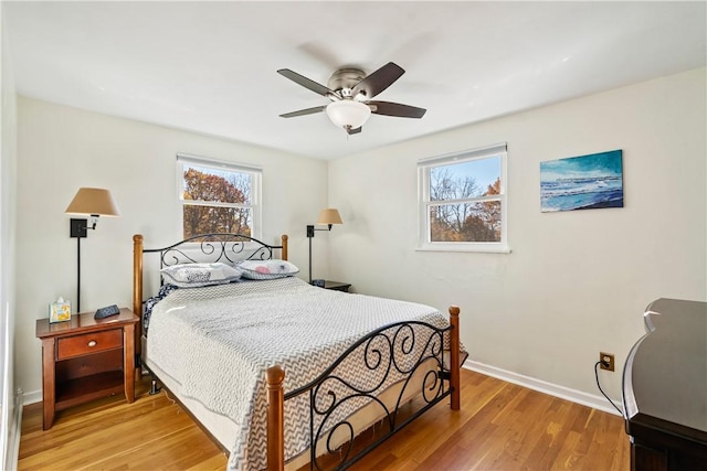 bedroom with hardwood / wood-style floors and ceiling fan