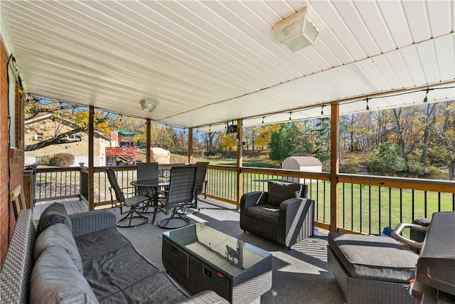 wooden terrace featuring a yard and an outdoor hangout area