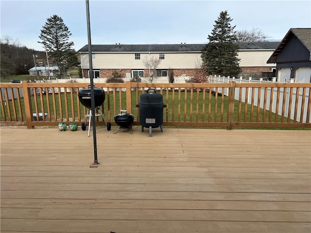 deck with a lawn and grilling area