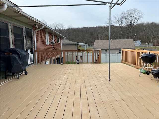 wooden deck featuring a grill