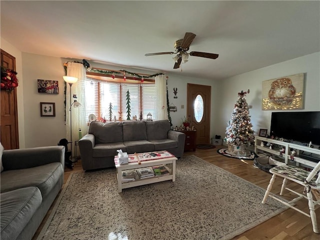 living room featuring wood-type flooring and ceiling fan