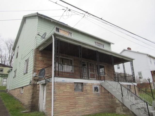 view of side of home with a porch