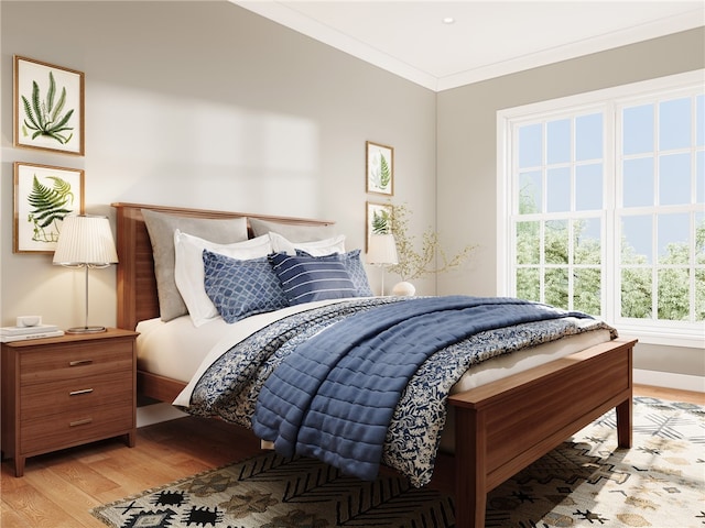 bedroom featuring crown molding and light hardwood / wood-style flooring