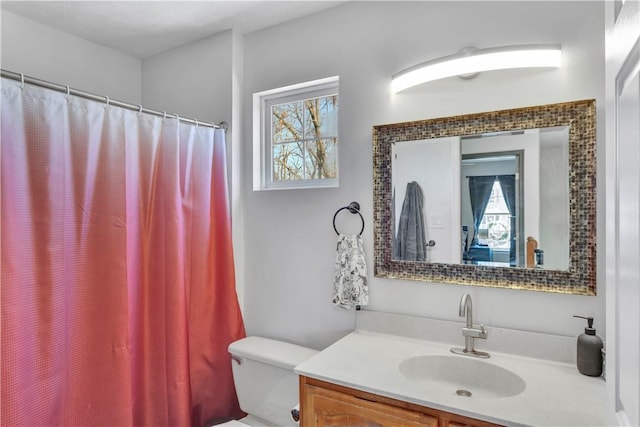 bathroom with vanity, toilet, and walk in shower