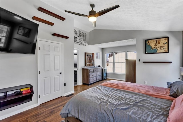 bedroom with ceiling fan, dark hardwood / wood-style flooring, and lofted ceiling