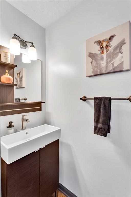 bathroom with vanity and a textured ceiling