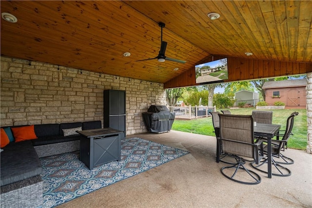 view of patio / terrace featuring outdoor lounge area, ceiling fan, grilling area, and a storage unit