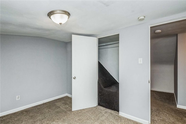 unfurnished bedroom featuring carpet flooring and a closet