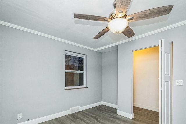 unfurnished room featuring dark hardwood / wood-style flooring and crown molding