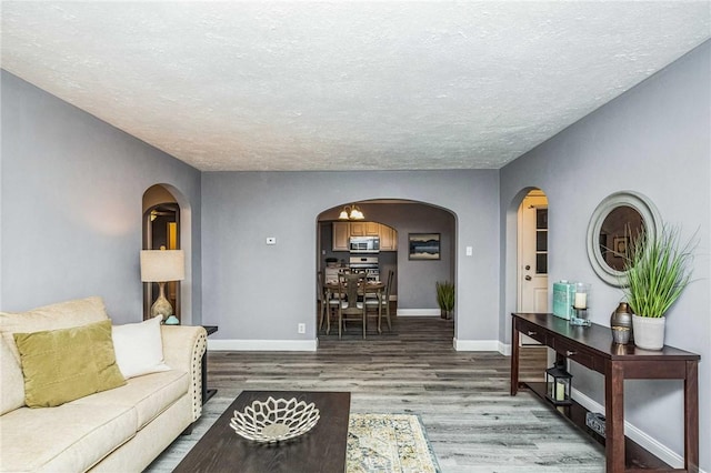 living room with hardwood / wood-style floors and a textured ceiling