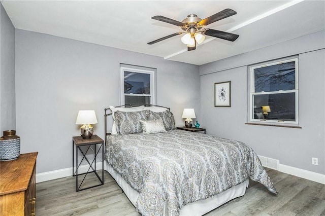 bedroom with hardwood / wood-style flooring and ceiling fan