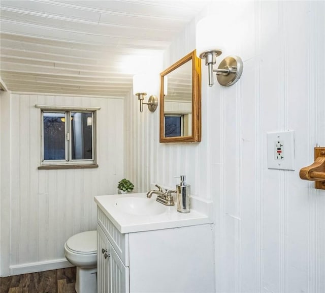 bathroom with vanity, hardwood / wood-style flooring, and toilet