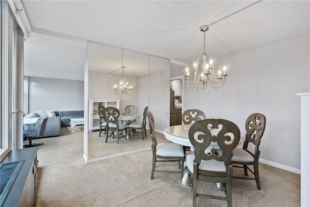 carpeted dining room with an inviting chandelier