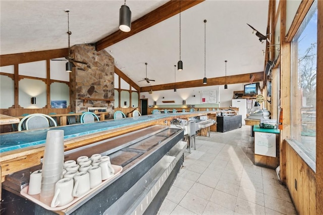 rec room featuring beamed ceiling, ceiling fan, light tile patterned floors, and high vaulted ceiling