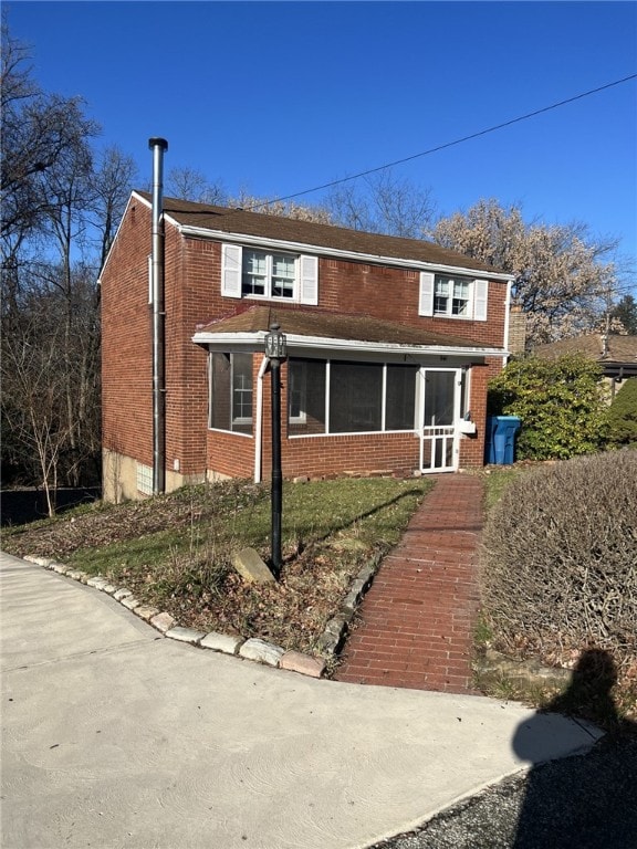 view of front of house featuring a sunroom