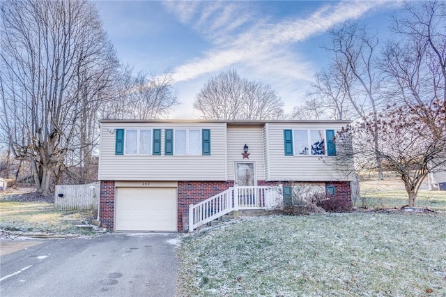 bi-level home with a front yard and a garage