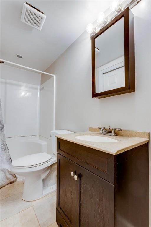 bathroom featuring tile patterned flooring, a shower with curtain, vanity, and toilet