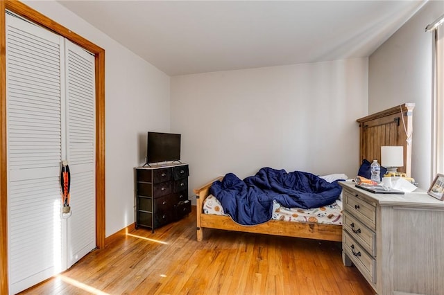 bedroom with a closet and light hardwood / wood-style flooring