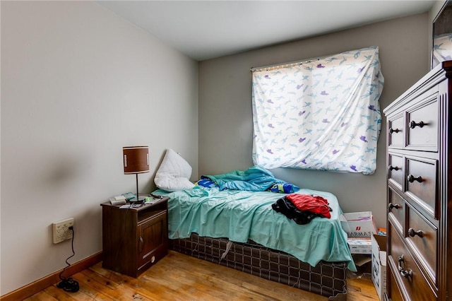 bedroom with light wood-type flooring