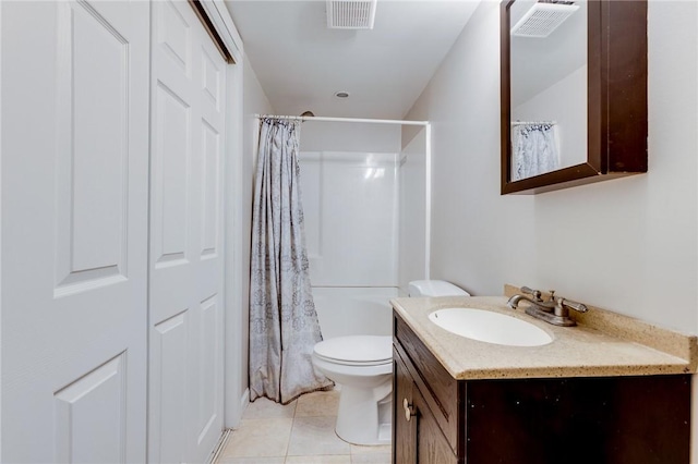 bathroom with tile patterned floors, a shower with curtain, vanity, and toilet