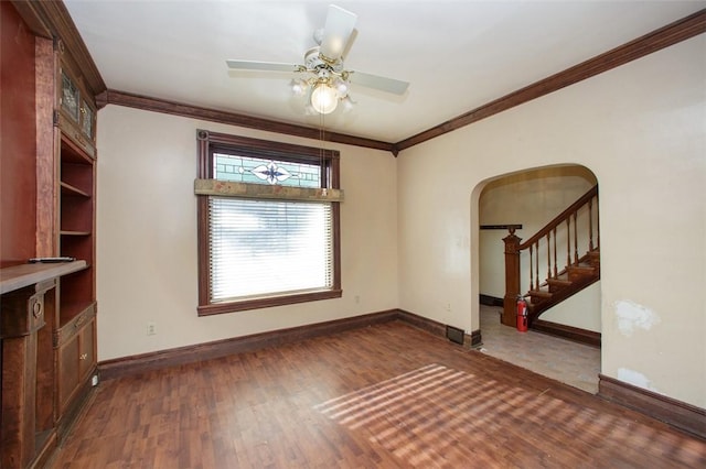 unfurnished living room featuring dark hardwood / wood-style flooring, ceiling fan, and ornamental molding