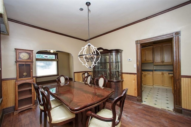 dining space featuring a chandelier, dark hardwood / wood-style flooring, and crown molding