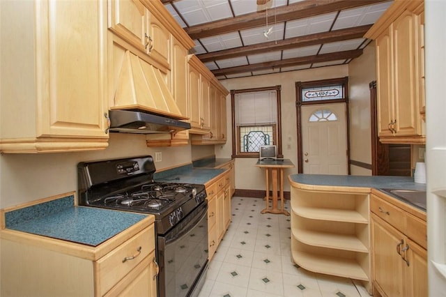 kitchen featuring light brown cabinets, gas stove, custom range hood, and sink